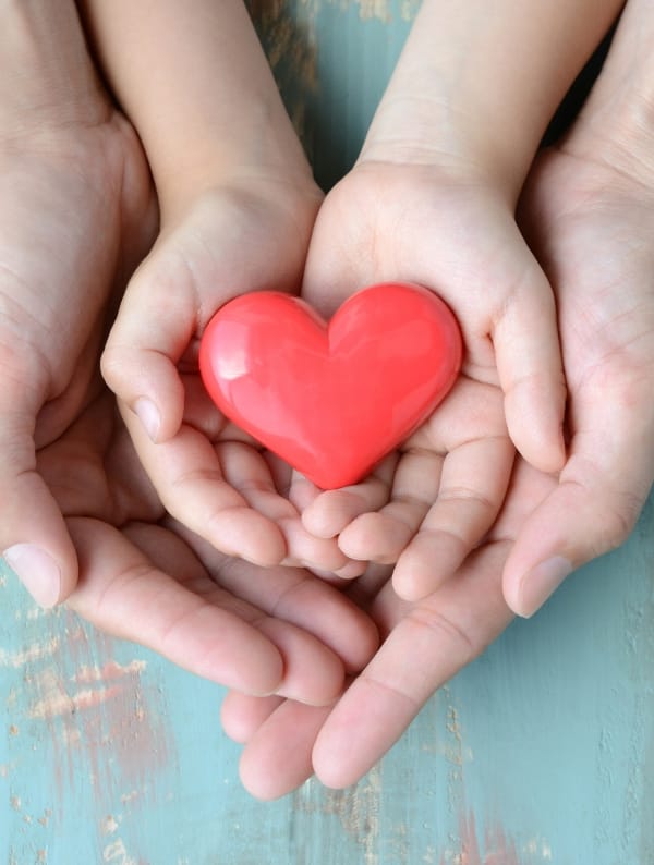 Hands holding a red heart