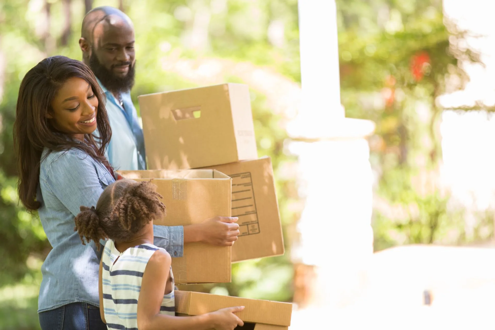 Family moving with cardboard boxes