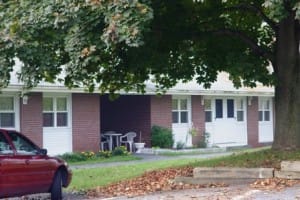 Red car by brick building